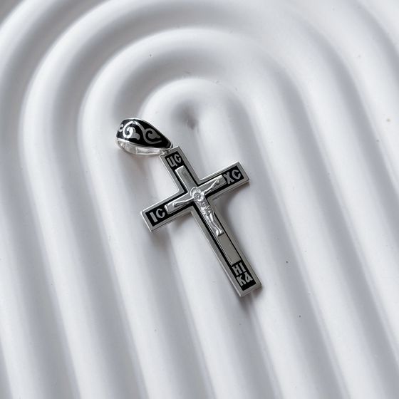A silver cross with a jewel