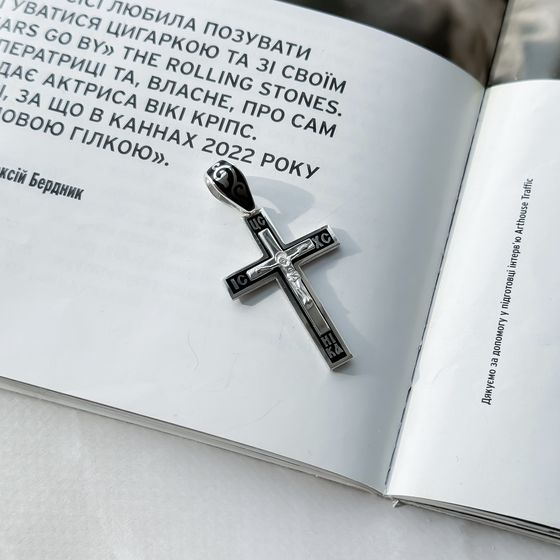 A silver cross with a jewel