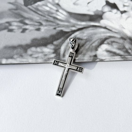 A silver cross with a jewel