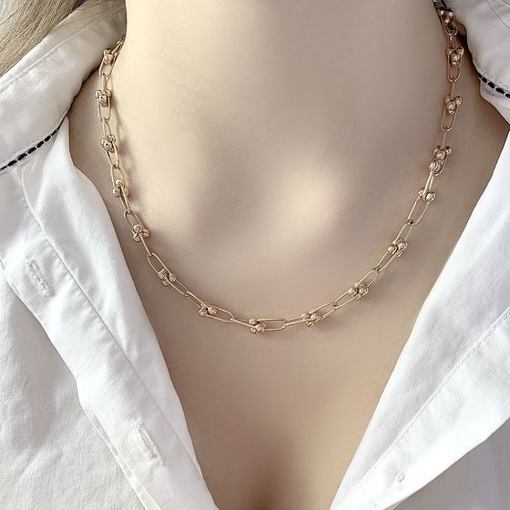 A gold necklace without stones