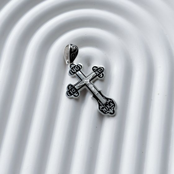 A silver cross with a jewel