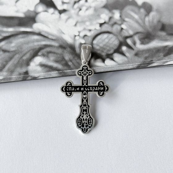 A silver cross with a jewel