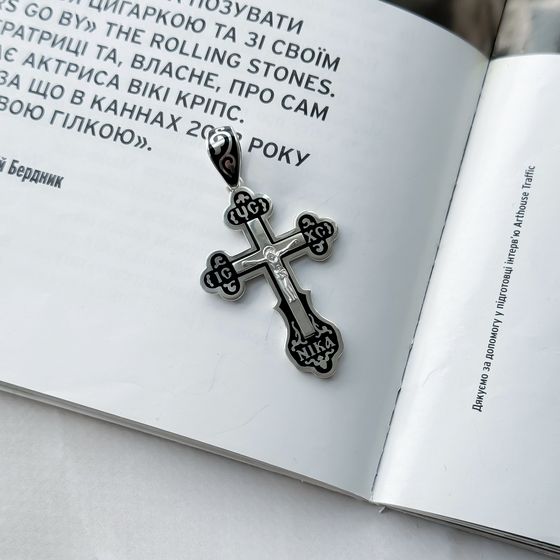 A silver cross with a jewel