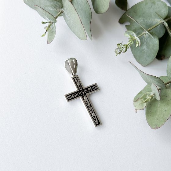 A silver cross with a jewel