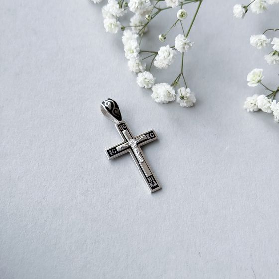A silver cross with a jewel