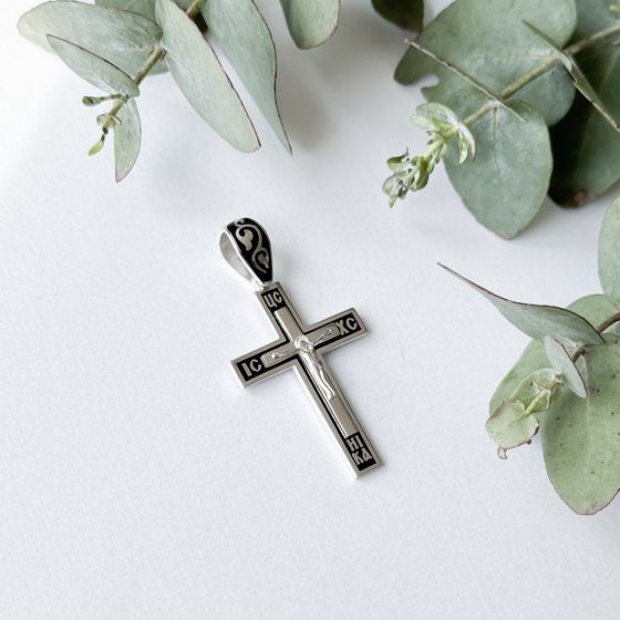 A silver cross with a jewel