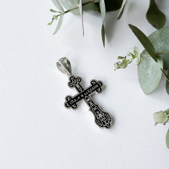 A silver cross with a jewel