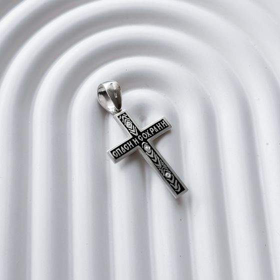 A silver cross with a jewel