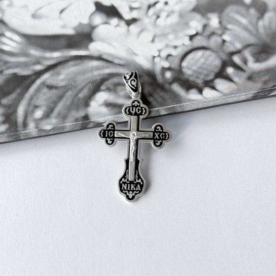 A silver cross with a jewel